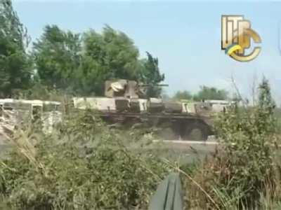 Ukrainian BTR-4 assists soldiers manning a checkpoint near Sloviansk in fending of a 