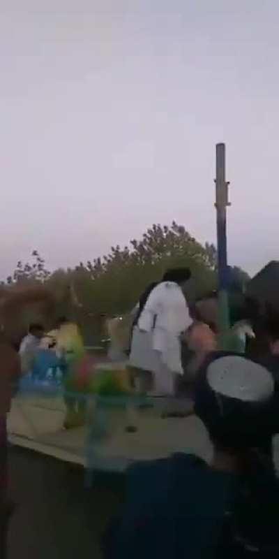 Taliban take control of an amusement park and ride a merry-go-round