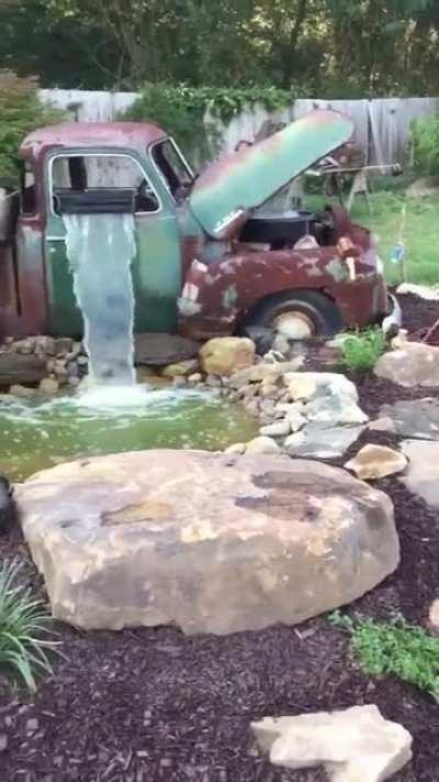 Pretty cool old car repurposed into garden waterfall