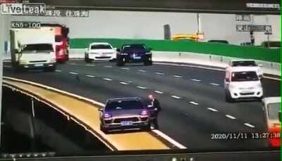 Truck runs over something in the road causing major crash