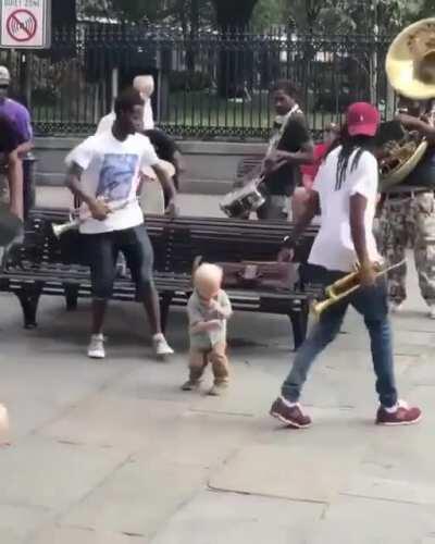 Little kid plays his heart out with street musicians