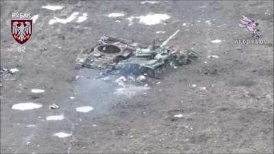 Ukrainian kamikaze drones hit two Russian soldiers hiding under a destroyed tank. March 2024