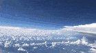 A neat POV of a plane passing by a giant storm system